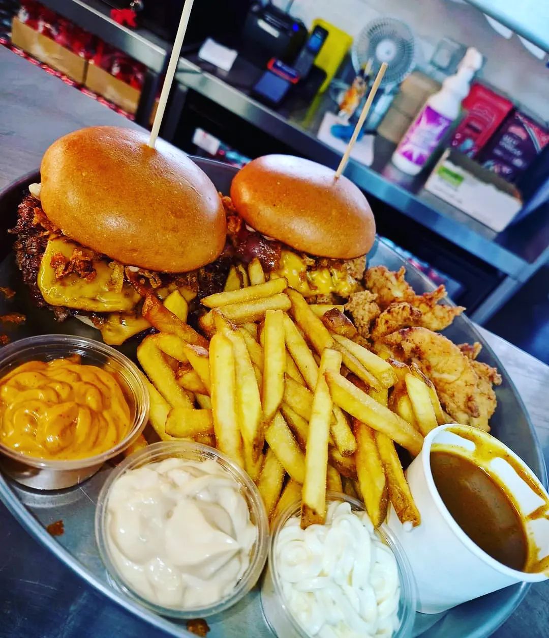 image of a platter of burgers, chips and dip.